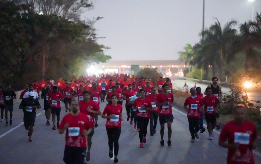Runners in red on the road at dawn
